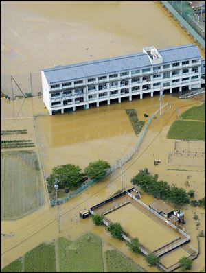 Kamodani junior high school compound and its vicinity area are flooded Sunday by the overflow of nearby Naka river, in Anan, western Japan.