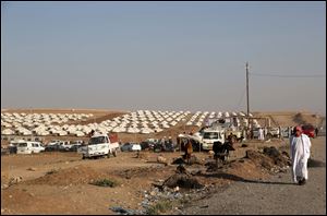 Displaced Iraqis from the Yazidi community settle at a new camp outside the old camp of Bajid Kandala at Feeshkhabour town near the Syria-Iraq border, Iraq, Friday.