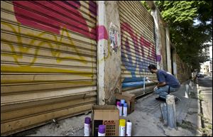 25-year old Lebanese graffiti artist, who goes by the name Phat 2, spray paints on abandoned shops in Beirut, Lebanon.