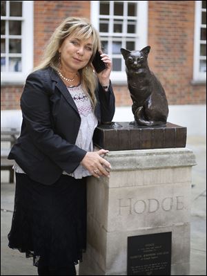 Helen Lederer next to a statue of Hodge the Cat at the launch of Talking Statues in central London today.
