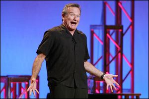 This Nov. 23, 2009 photo released by Starpix shows actor-comedian Robin Williams performing his stand-up show, Weapons of Self Destruction, at Town Hall in New York. 