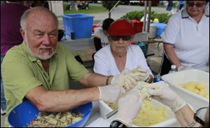 Volunteers Joe Gates and Marge Hartkopf peel potatoes for potato salad at the German American Festival at Oak Shade Grove.