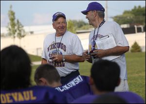 Co-head coaches Harold Keaton, left, and Dave Wendt attend an award ceremony after lightweight football practice at DeVeaux Elementary School in North Toledo. The ceremony took place Wednesday.