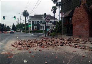 Bricks are in the street after a building was damaged during an earthquake Sunday in Napa, Calif.