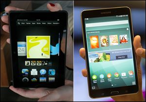 The 7-inch Amazon Kindle HDX tablet, left, and the Samsung Galaxy Tab 4 Nook are on display.