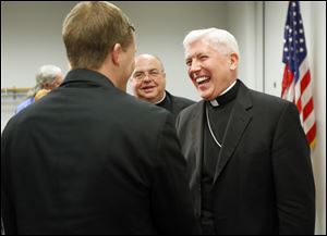 Bishop Daniel E. Thomas, who was just named the new bishop of Toledo, meets Cincinnati Seminarian Thomas DeStazio after giving his first public address at the Catholic Center.