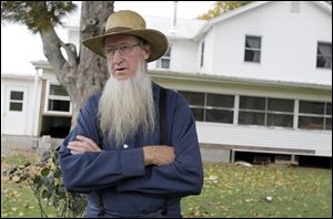 Sam Mullet stands in front of his Bergholz, Ohio, home. An appeals court on Wednesday, Aug. 27, 2014  overturned the hate-crime convictions of 16 Amish in beard- and hair-cutting attacks on fellow members of their faith in Ohio.