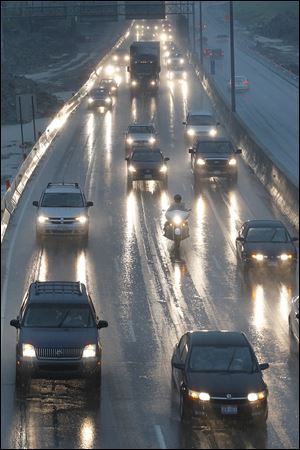 Despite horrific weather at times, Toledo commuters — here on I-475 West — have lower costs than in most cities, a report says.