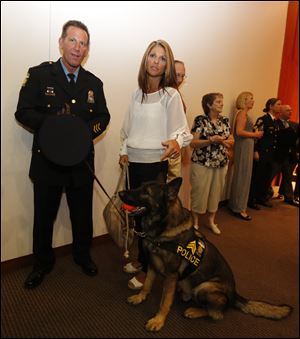 Sgt. Joe Taylor, left, his wife Amie, and Sgt. Joker. Both sergeants Taylor and Joker were promoted in today's ceremony.