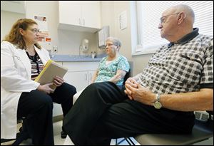 Chris Ludwig, RN Ambulatory CareNavigator at ProMedica Physicians Group, left, counsels Sherron Kern and her husband, Lowell Kern.