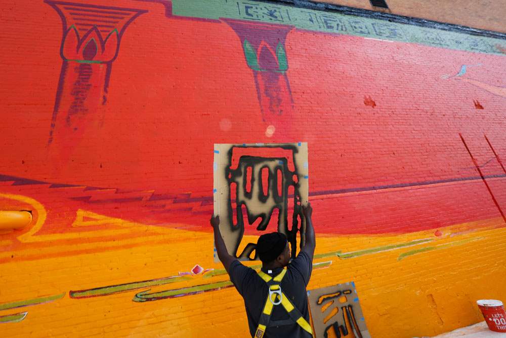 MAG-mural21pYusef-Lateef-holds-up-one-of-the-ste