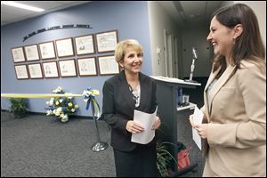 Judge Arlene Singer, left, and Lindsay Navarre, president of the Toledo Women’s Bar Association, helped unveil the Toledo Women Lawyers History Project on Thursday.