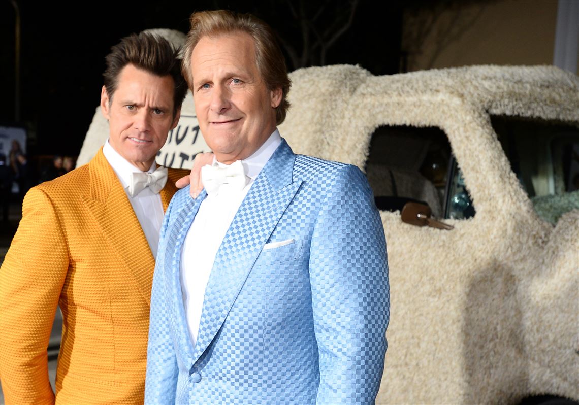 Jim Carrey, left, and Jeff Daniels reprise their roles as painfully dim pals Harry and Lloyd in “Dumb & Dumber To,” opening Friday.