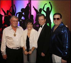 From left, Maumee Rotary President Greg Fish, with Michele Free, event chairman Tom Cox, and Jeff Keim at the Maumee Rotary's 'Rotary Night Fever' charity auction. 