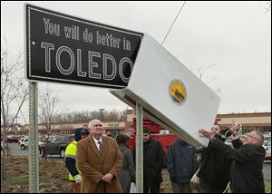 City officials unveil the first ‘You will do better in TOLEDO’ road sign on Reynolds Road and Heatherdowns Boulevard.
