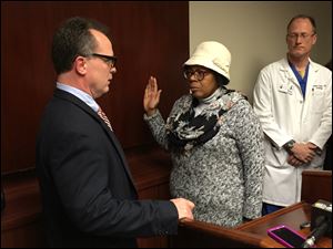 Paula Hicks-Hudson sworn in by law director Adam Loukx.