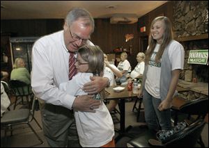 In 2009, mayoral candidate D. Michael Collins hugged his granddaughter Sara Dickey 10, while another granddaughter Liz Dickey, 17, watched at a gathering of volunteers and supporters of his campaign at the Toledo Police Patrolman’s Association Union Hall.