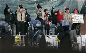 Members of the National Socialist Movement, including Bill White, at center behind a helmeted officer, rally in front of One Government Center on Oct. 25, 2005. 