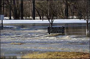 Water reaches the middle of the sign in Side Cut Park flooding the entire area.