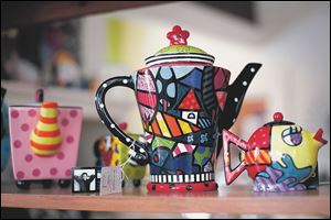 A variety of teapots and their accessories, including pieces by Romero Britto, are featured at Clara J's Tea Room in Maumee.