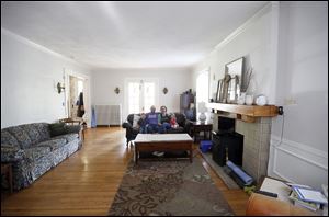 The Rye family, from left, Jonah, 5,  Jamie, Kelly, and Jane, 2, sit in the huge living room of their Old West End house. 