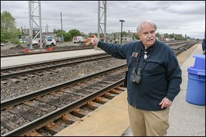 Tony Phillips points to the condo in Chicago where he lives on the other side of the tracks at the Halsted Station, where oil trains pass by.
