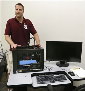 Director Mark Bowlus shows off a 3D machine in the BiG Fab Lab. The self-employed engineer created the for-profit lab and opened the 16,000 square-foot space in April.  