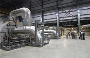 Men tour of AMP Fremont Energy Center, a natural gas-run electric plant.