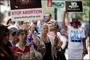 Anti-abortion activists demonstrate near a Planned Parenthood clinic Tuesday, in Philadelphia. Also, roughly 200 people rallied at the Ohio Statehouse as part of a national protest.
