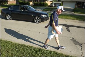 Former Toledo Mayor Carty Finkbeiner, 76, campaigns on Regina Parkway near Goodwood. He has not officially declared for the Nov. 3 mayoral election, but he isn’t taking a chance on not working hard enough as a candidate.