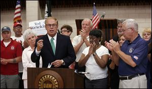 Former Ohio Governor Ted Strickland, at podium, who is running for U.S. Senate, is endorsed by the UAW during an announcement at UAW Local 12 Hall in Toledo Tuesday.