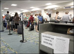 Passengers for an Allegiant Air flight wait to check in at Toledo  Express. Falling fuel prices and a jump in Allegiant traffic have lifted the airport to its best year since 2009.
