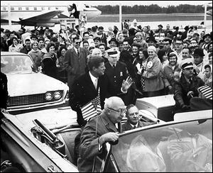 John F. Kennedy waves to onlookers after landing at Toledo Express Airport during the 1960 presidential campaign. 