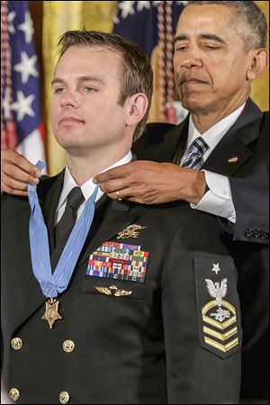 President Barack Obama presents Navy Senior Chief Edward Byers, Jr., with the Medal of Honor in a ceremony at the White House last year. Mr. Byers is a 1997 Otsego High graduate.
