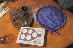 A hat is in the process of being knitted by Barbara Knipple at the Black Cloister Brewing Co.