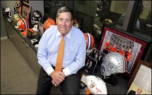 Mike Wilcox sits with sports memorabilia in his office in this 2016 file photo.