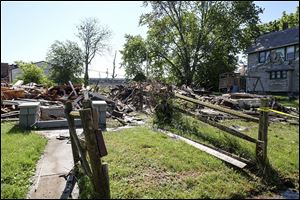 Fires destroy two homes in the 2400 block of Trenton Avenue in Toledo. Local officials are investigating whether they are related to recent arsons and shootings in the city.