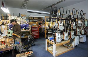 Guitar techs Zack Green and Chris Zielinski work in the guitar workshop at Reverend Guitars in Sylvania.
