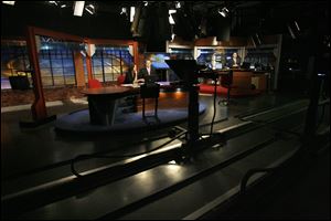 Laura Rice and Chance Walser anchor the Channel 24 newscast in 2010.