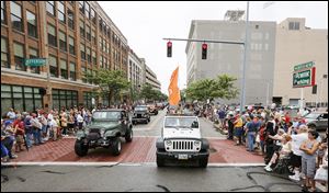 Jeeps parade down North Huron Street for Jeep Fest in Toledo on Aug. 13, 2016. 
