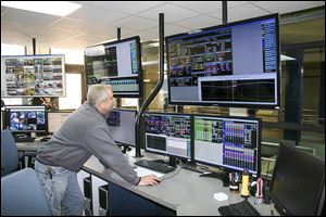 Mike Robe of the Oak Creek Water and Sewer Utility works at the control panel of the Oak Creek water treatment plant in Oak Creek, Wis.