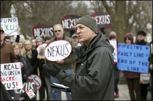 In this file photo, Andrew Kear, an associate professor with Bowling Green State University, center, calls on Nexus Gas Transmission (NEXUS) to reroute their proposed new pipeline at Farnsworth Metropark near Whitehouse.