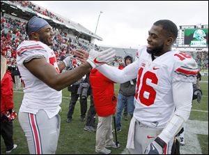 Ohio State will have to replace multiple-time captains J.T. Barrett, right, and Tyquan Lewis in 2018.