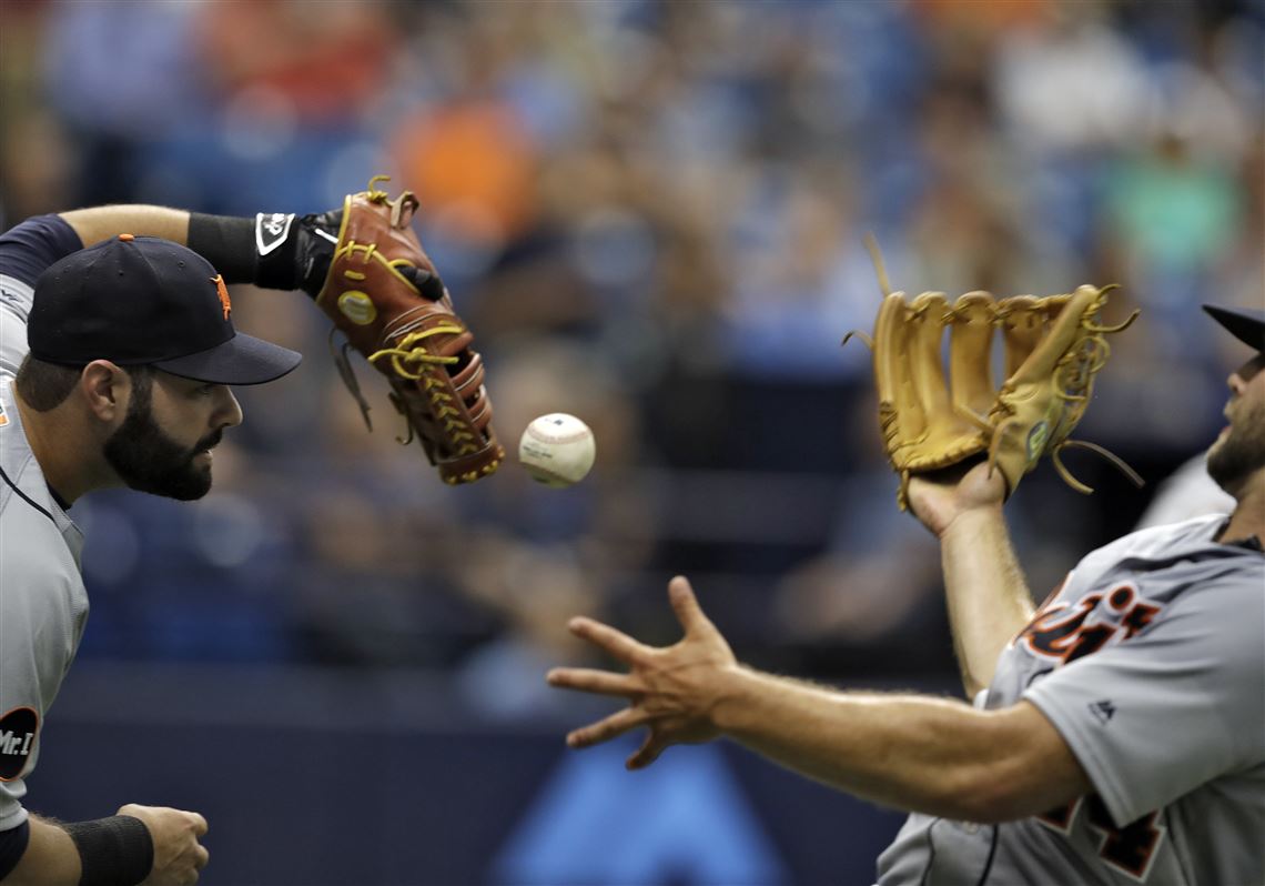 Detroit Tigers first baseman Alex Avila, left, and starting pitcher Daniel Norris misplay a pop foul during Thursday's game against the Tampa Bay Rays.