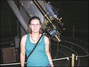 Kathyrn Volk at an observatory in Arizona. Volk, who grew up in Ottawa Hills, may have discovered a planet at the far edge of our solar system.