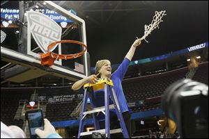 Toledo head coach Tricia Cullop celebrates after the Rockets women's basketball team won the MAC tournament in Cleveland. The win allowed UT to return to the NCAA tourney for the first time since 2001.