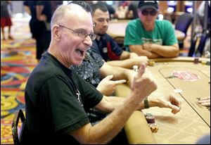 Deaf poker player Achille Buzzelli signs during the Hollywood Casino's 