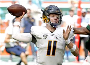 Toledo quarterback Logan Woodside throws a pass during the first half of a September game against Miami.