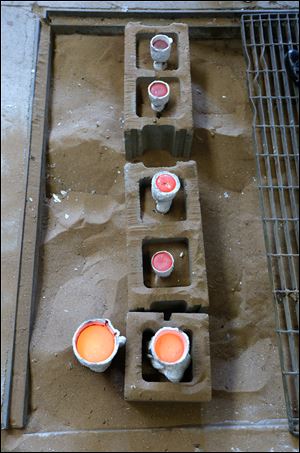 Poured molds cooling in the sands.