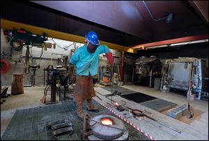 Jerod Christy, technical assistant in 3d and sculpture, in the foundry.
